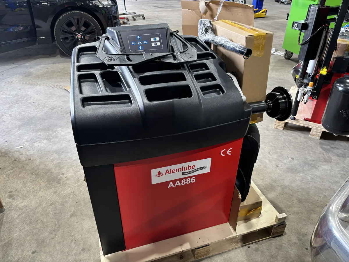 A wheel balancer on its pallet in the workshop.