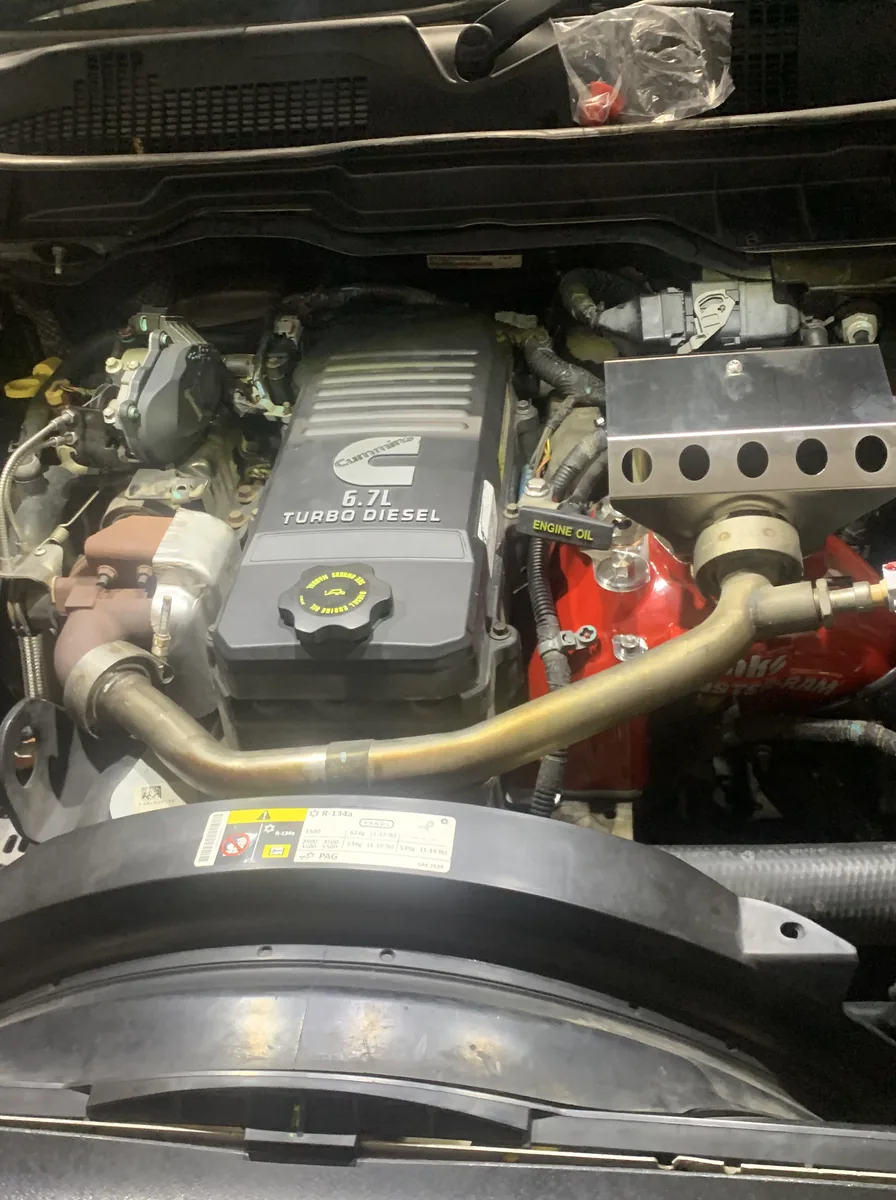 The engine bay of a Cummins turbo diesel ute with its bonnet open.